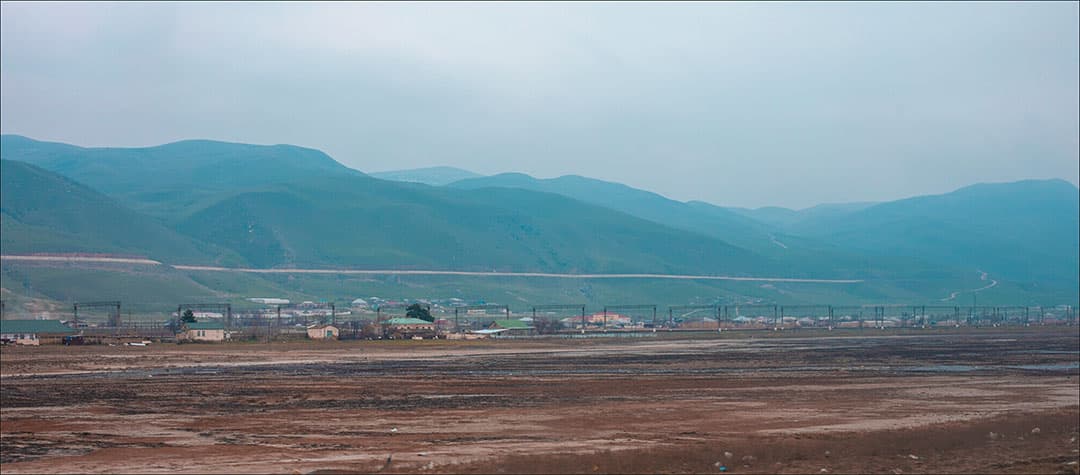 A small town in a valley below the mountains
